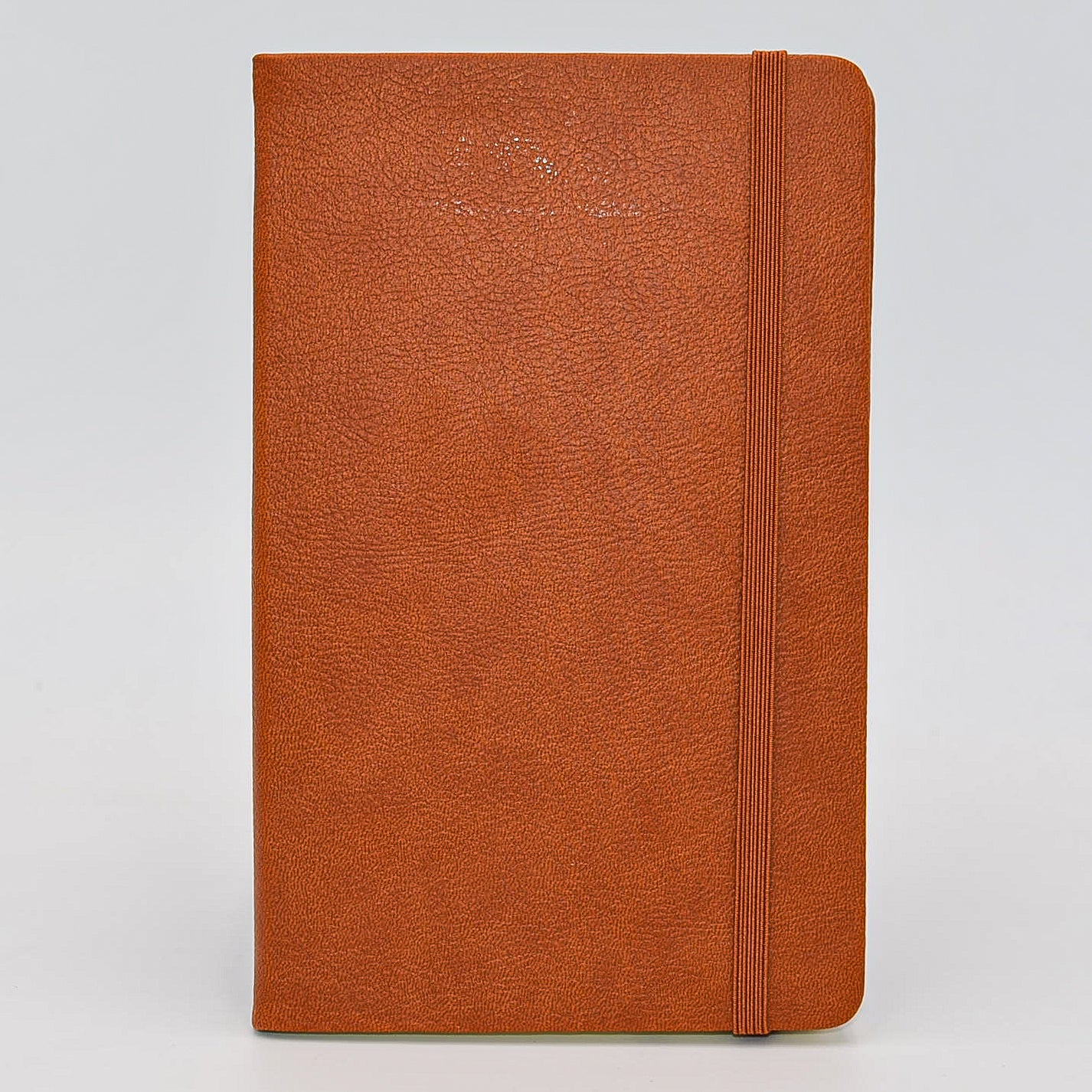 Journal: Faux Leather Lined Case Bound Book with Elastic Closure  This vegan leather ruled journal is perfect for your travels, home, car, or office. With a convenient elastic band closure, keep your book closed with ease. With ivory ruled pages, keep easy notes throughout your day.  Available in Tan, White, and Blue  Dimensions: 5" x 8" tan british tan brown light brown