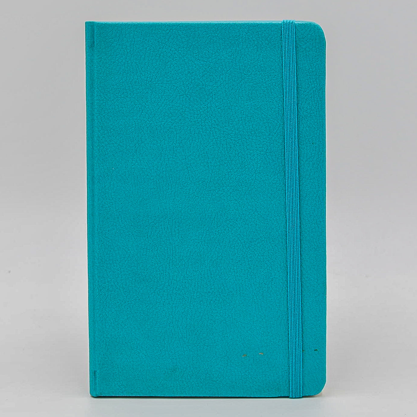 Journal: Faux Leather Lined Case Bound Book with Elastic Closure  This vegan leather ruled journal is perfect for your travels, home, car, or office. With a convenient elastic band closure, keep your book closed with ease. With ivory ruled pages, keep easy notes throughout your day.  Available in Tan, White, and Blue  Dimensions: 5" x 8"  5x8 5 x 8 light blue teal turquoise