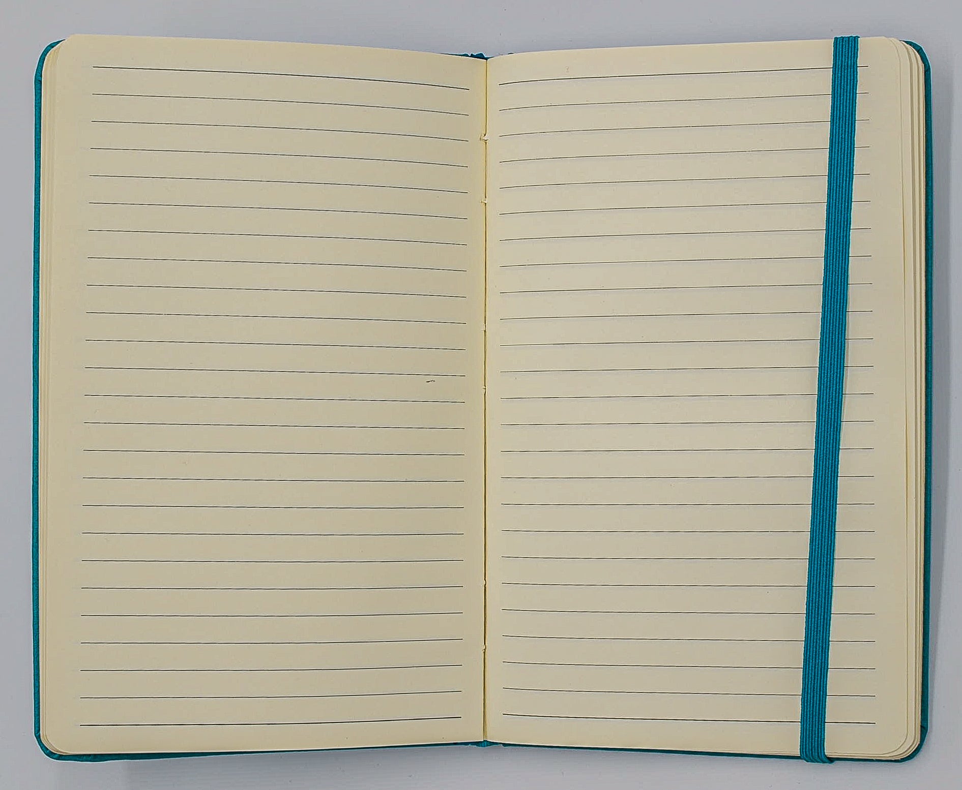 Journal: Faux Leather Lined Case Bound Book with Elastic Closure  This vegan leather ruled journal is perfect for your travels, home, car, or office. With a convenient elastic band closure, keep your book closed with ease. With ivory ruled pages, keep easy notes throughout your day.  Available in Tan, White, and Blue  Dimensions: 5" x 8"  5x8 5 x 8 light blue teal turquoise