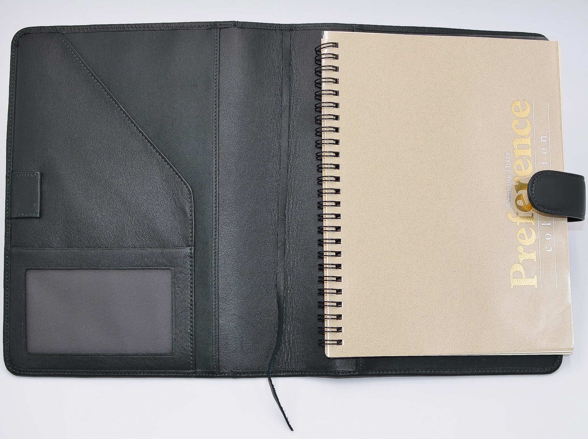 This leather cover is available in British Tan, Red, Burgundy, Green, Black, and Brown. This 7-1/2" x 9-3/4" cover accommodates wire bound and loose leaf inserts with an optional metal 3-ring binder. Keep yourself organized with ease with a snap closure, horizontal note pad holder, clear identification holder, document holder, and leather book mark.