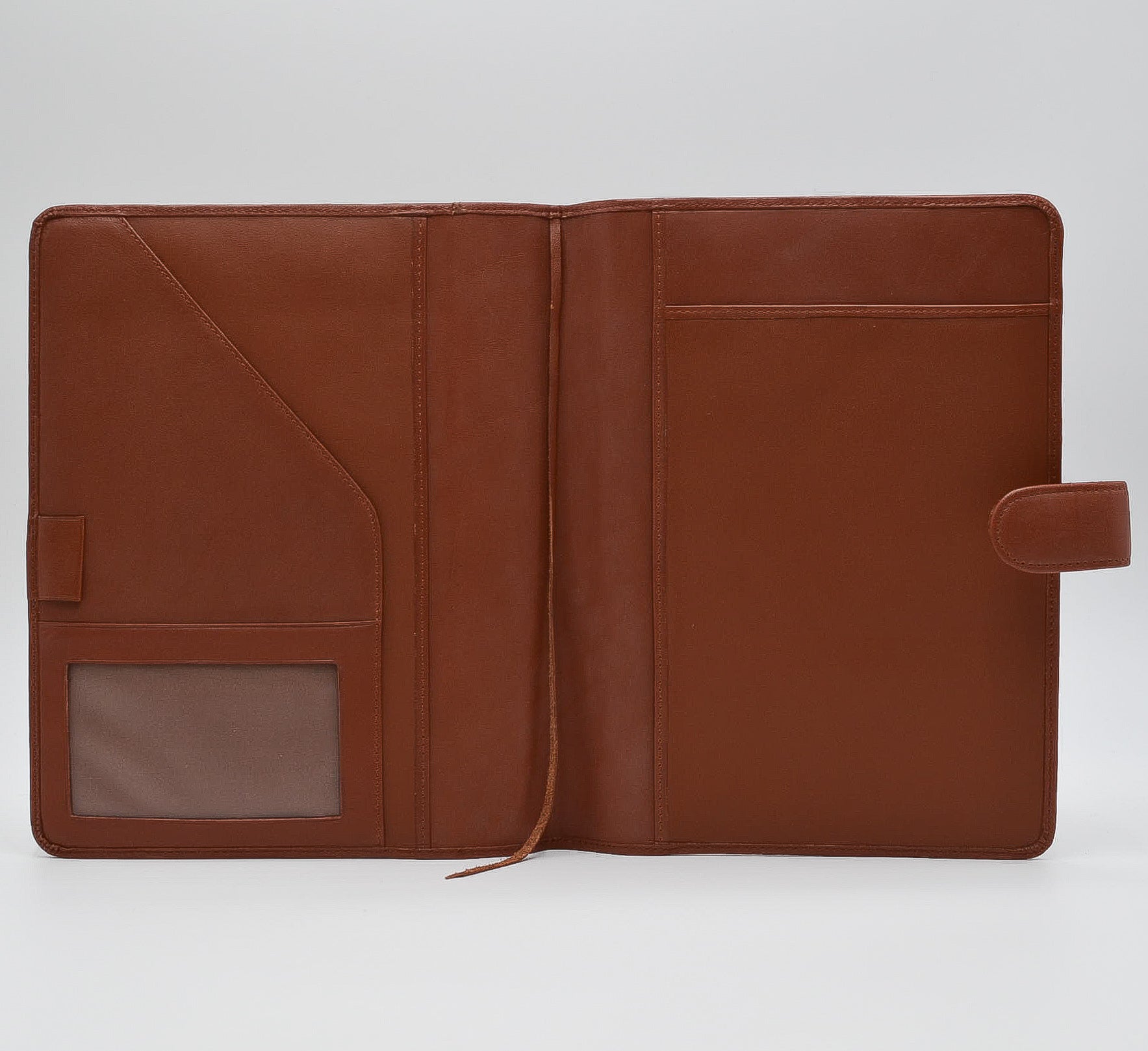 This leather cover is available in British Tan, Red, Burgundy, Green, Black, and Brown. This 7-1/2" x 9-3/4" cover accommodates wire bound and loose leaf inserts with an optional metal 3-ring binder. Keep yourself organized with ease with a snap closure, horizontal note pad holder, clear identification holder, document holder, and leather book mark.